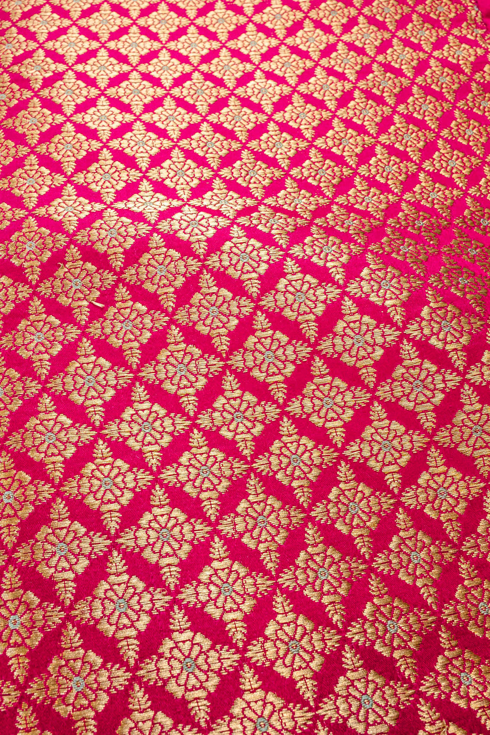 Handwoven reddish-pink silk brocade fabric