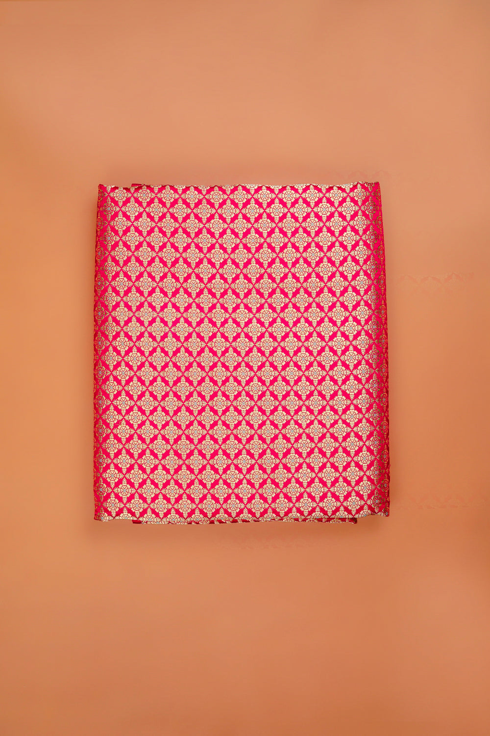 Handwoven reddish-pink silk brocade fabric