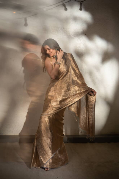 Karishma Tanna in our handwoven molten gold shikargah tissue saree