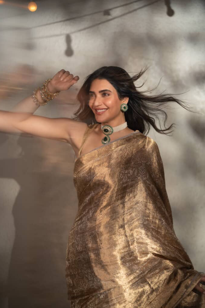 Karishma Tanna in our handwoven molten gold shikargah tissue saree