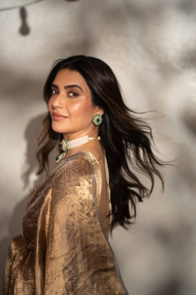 Karishma Tanna in our handwoven molten gold shikargah tissue saree